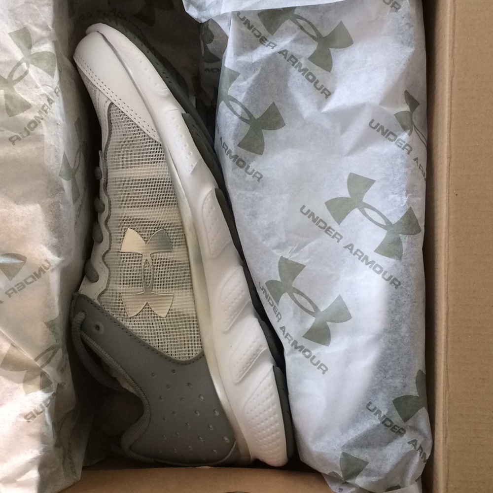 Discontinued brand new Under Armour white and silver athletic shoes.